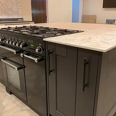 A kitchen with a stove and a counter top.
