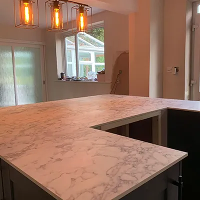 A kitchen with a large marble counter top.
