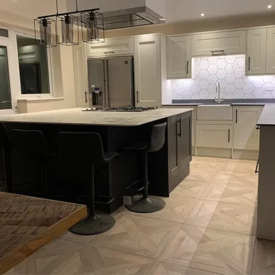 A large kitchen with a center island in the middle of the room.