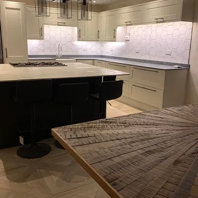 A large kitchen with a wooden table in it.