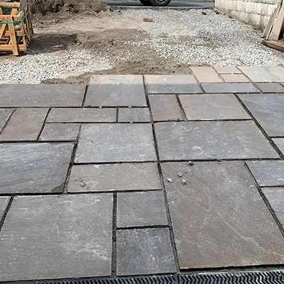 A car parked in a driveway next to a building.