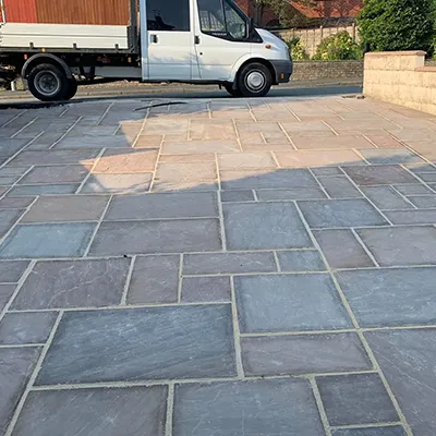 A delivery truck is parked in a driveway.