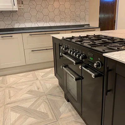 A kitchen with a stove, oven and cabinets.