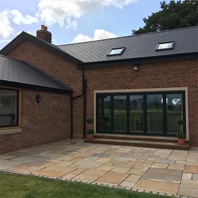 A brick house with a large patio and a patio area.
